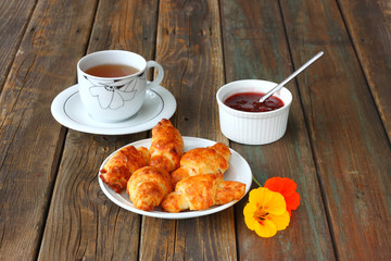 Breakfast with tea homemade croissants and jam