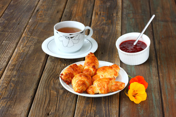 Breakfast with tea homemade croissants and jam