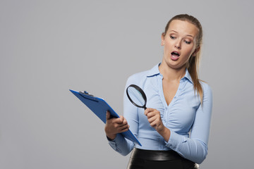 Shocked woman looking at office documents