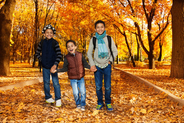 Naklejka premium Three brothers in autumn park