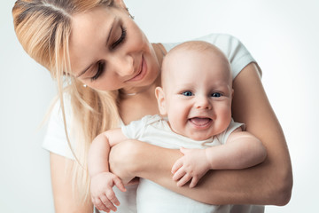 Young mother hugging baby