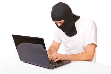 Man in black mask looking at monitor