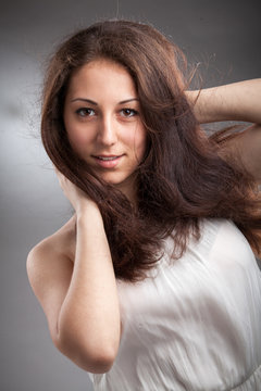 Closeup portrait of beautiful brunette woman in white singlet