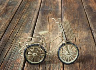miniature bicycle on wooden table. vintage concept