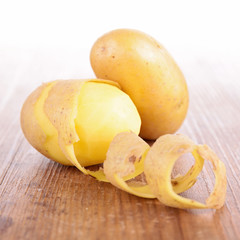 raw potato on wood background