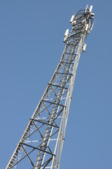Telecommunication tower against the blue sky 