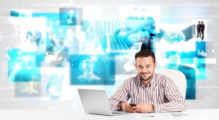 Business person at desk with modern tech images at background