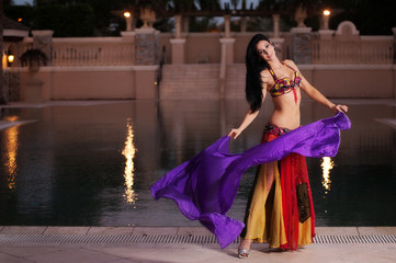 Belly Dancer in Red Costume Dances with Purple Veil