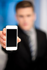 Salesman displaying newly launched mobile