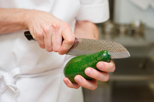 Chef Is Cutting Avocado With Knife