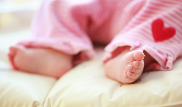 Cute baby foot in cot