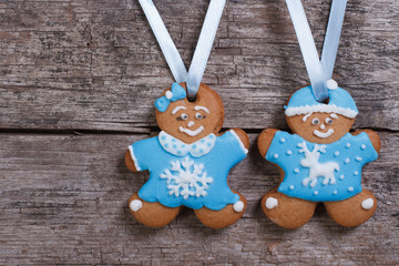 Two blue gingerbread men. Girl with bow and the boy in a hat
