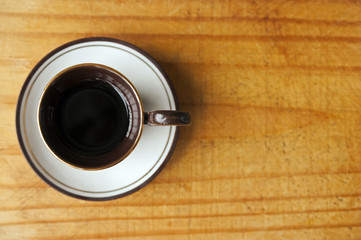 Obraz na płótnie Canvas Cup of coffee on wood background