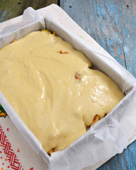 Dough with apples on a baking sheet for roasting. Not baked