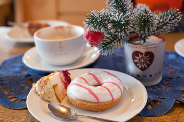 A donate with white glaze on plate in cafe