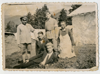 CIRCA 1950: Group of men, probably army cook, laborer, and a man