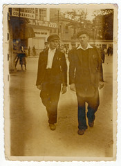Two young men walking around town circa 1935