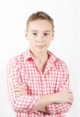 Caucasian teenager standing in checkered shirt, white background