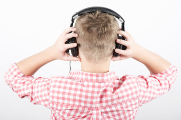 Teenager listens music with headphones, rear view