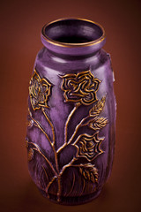 Ancient clay vase on brown background