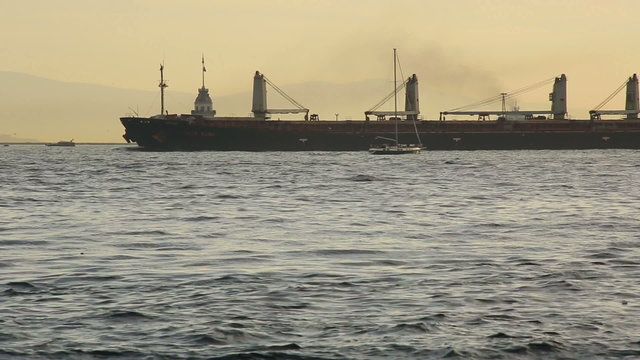 time lapse large cargo ship passing Maiden Tower