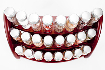  spice rack full of a variety of different spices and herb 