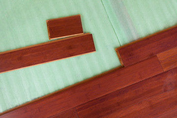 Wooden bamboo hardwood flooring planks being layed