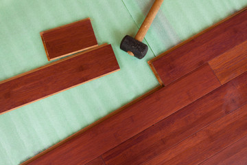 Wooden bamboo hardwood flooring planks being layed