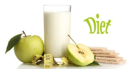 Glass of yogurt, green apples, crispbreads and measuring tape