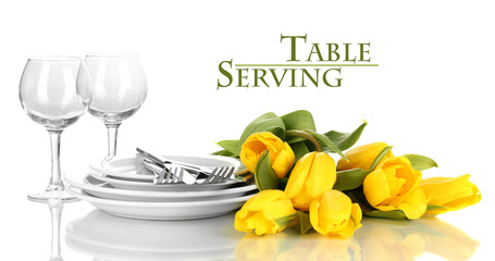 Yellow tulips and utensils for serving isolated on white