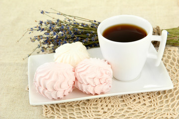Marshmallows on plate on light background
