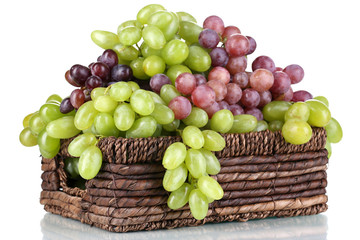Ripe green and purple grapes in basket isolated on white