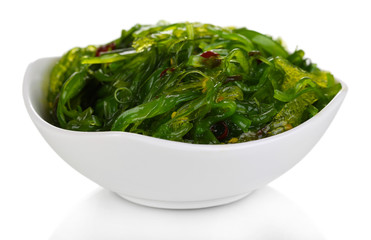 Sea kale in bowl close-up isolated on white