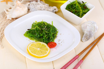 Sea kale on plate on wooden table close-up