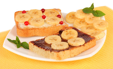 Delicious toast with bananas on plate close-up