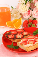 Delicious toast with strawberry on plate close-up