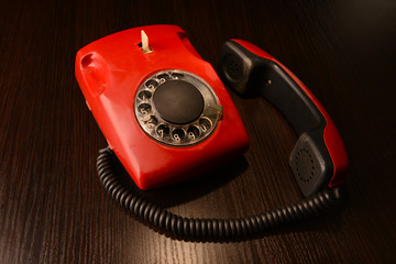 Red retro telephone,on dark background