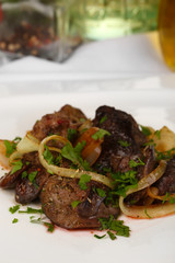 Appetizing fried chicken livers on plate close-up