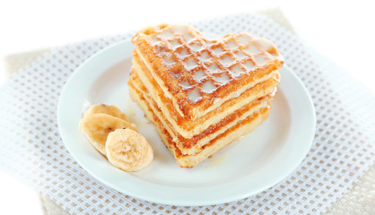 Sweet Belgium waffles with banana, isolated on white