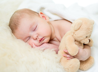 infant baby sleeping with plush toy