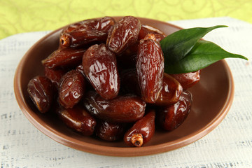 Dried dates on plate on table close up