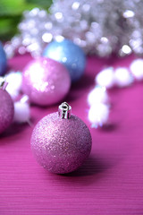 Christmas balls on fir tree, on color background