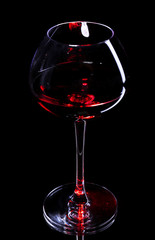 Wineglass with red wine, isolated on black