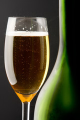 Wine glass and Bottle, isolated on black background.