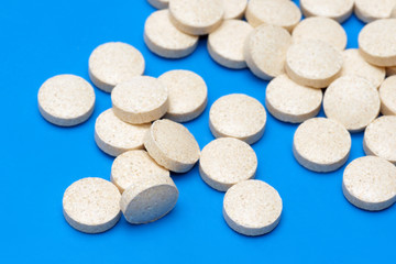 Fototapeta na wymiar Pills, capsules on blue background, Pharmacy, Medicine