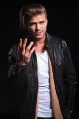 Obraz premium young man in leather jacktes asking you what do you want