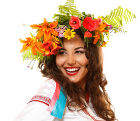 Beautiful ukrainian young woman in garland of summer flowers and