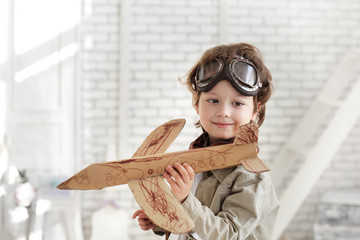 happy boy with jet airplane in hand