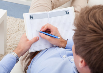 Young man writing in diary