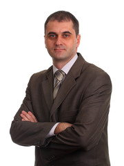 Businessman in suit with crossed arms on white background